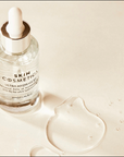 Flat lay of Ultra Hydrate B5 serum ingredients, highlighting hyaluronic acid and vitamin B5 with natural elements.