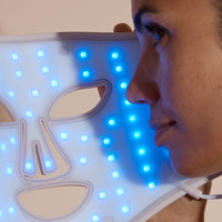 Solaine Pro LED face mask displaying blue light therapy in use, targeting acne and blemishes for clearer skin.