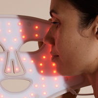Solaine Pro LED face mask showcasing red light therapy in use, promoting skin rejuvenation and reducing the appearance of fine lines