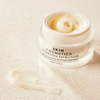 Close-up of Skin Cosmetica Microderm Exfoliator to damp skin, demonstrating its smooth texture.