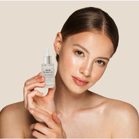 Pure Hyaluronic Acid Serum to damp skin, illustrating its lightweight texture.