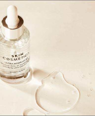 Flat lay of Ultra Hydrate B5 serum ingredients, highlighting hyaluronic acid and vitamin B5 with natural elements.