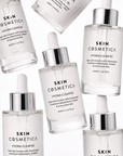 Multiple Skin Cosmetica Hydra Clear B3 serum bottles arranged in a luxury flat lay composition, showcasing a hydrating niacinamide serum for clear, balanced and healthy-looking skin.