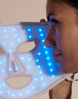 Solaine Pro LED face mask displaying blue light therapy in use, targeting acne and blemishes for clearer skin.