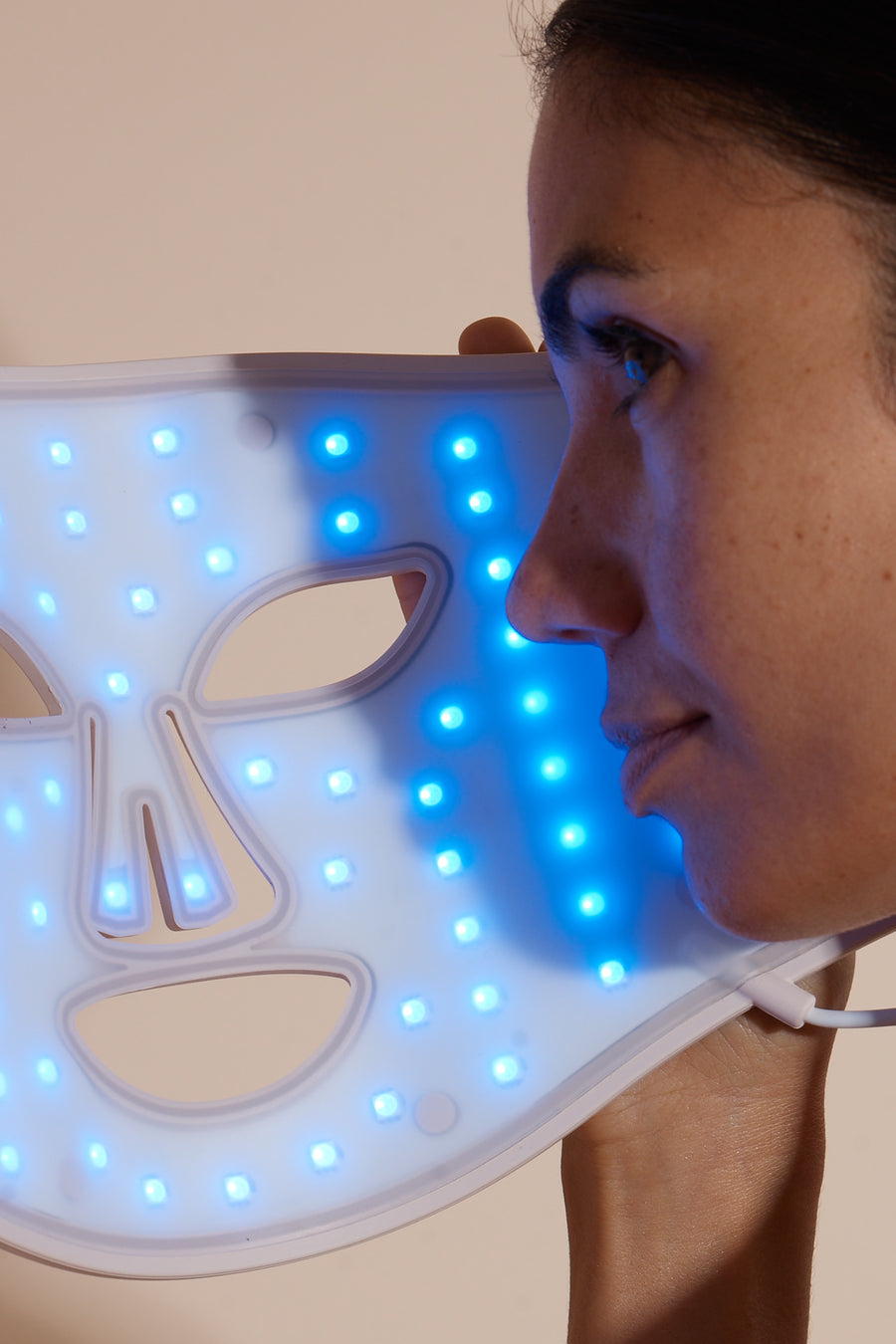Solaine Pro LED face mask displaying blue light therapy in use, targeting acne and blemishes for clearer skin.