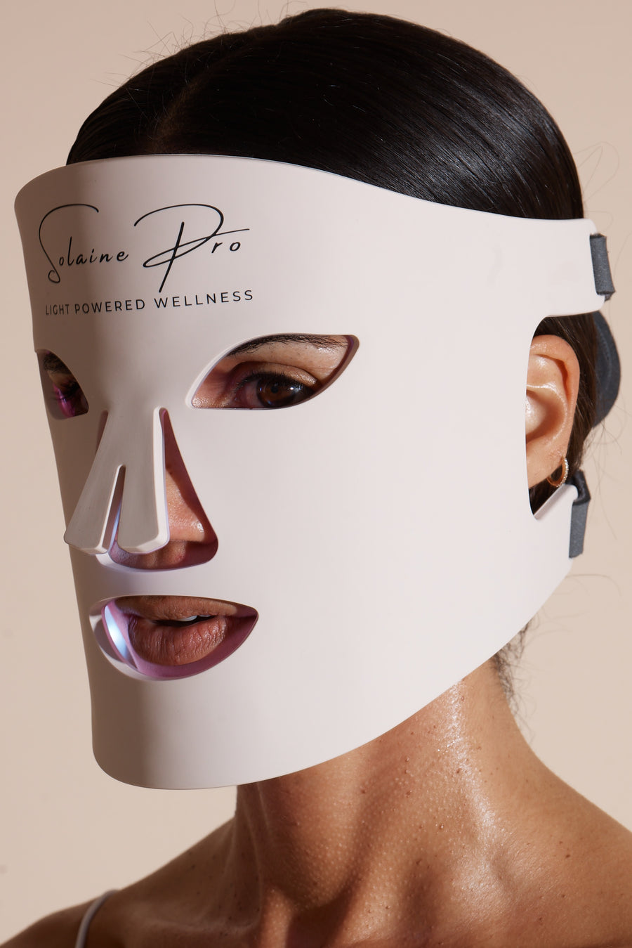 Close-up of the Solaine Pro LED face mask on a model, emphasizing the mask's powerful light therapy for improved skin health